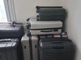 several pieces of luggage are stacked on top of each other in a room
