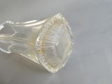 un vase en verre transparent posé sur une table recouverte d'une nappe blanche