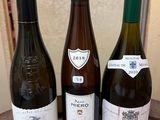 three bottles of wine sitting on a table next to each other