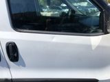a dog sitting in the driver ' s seat of a white truck
