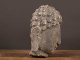 a close up of a statue of a head on a wooden table