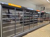 many empty refrigerators in a store that are empty