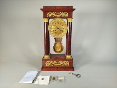 a clock that is sitting on a table next to a pair of scissors