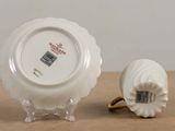 a small white plate and a small white plate on a table