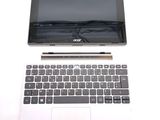 a white laptop with a black keyboard on a white surface