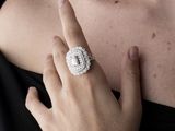 someone is wearing a ring that has a diamond on it