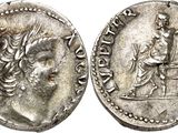 a silver coin with an image of a man holding a sword