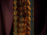 a glass vase filled with dried food sitting on top of a table