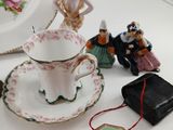 a white table topped with a tea cup and saucer
