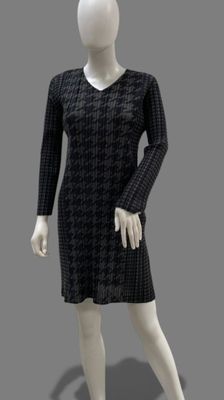 mannequin dressed in a black and white dress on a gray background