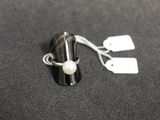 a ring with a pearl on it sitting on a table