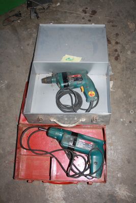 a box with a drill and a cord in it