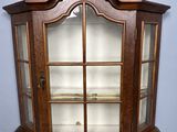 an old wooden display case with glass doors