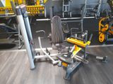 yellow and black gym equipment in a gym room with wooden flooring