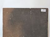 a brown piece of luggage sitting on a white surface