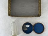 a bottle of water, a container of soap, and a tray of soap on a white surface