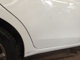 a white car that has been painted white in a garage