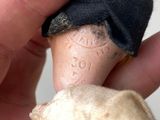 a hand that is holding a small piece of cloth