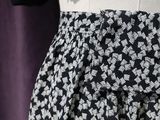 a close up of a skirt with a black and white pattern