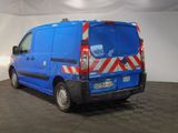 a blue van with red and white stripes parked in a room