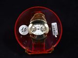 a watch that is sitting in a glass container