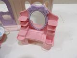 a small doll house with a mirror and a vanity