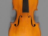 an old violin with a bow on a gray background