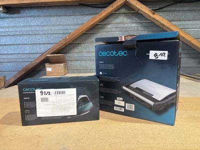 two boxes of a laptop computer sitting on top of a wooden table