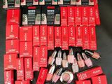 some of the lipsticks are sitting on the black surface