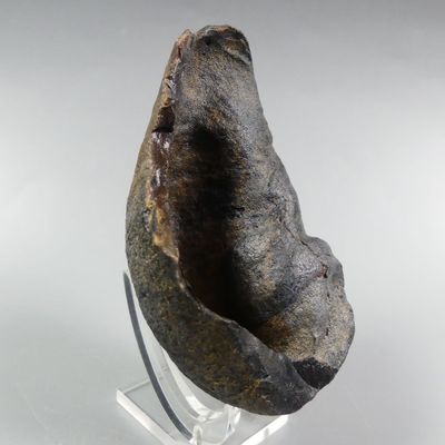 an image of a piece of rock on a stand on a white surface