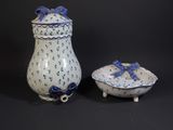 pair of blue and white vases with bows and bows on them