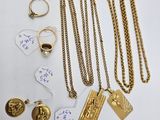 a close up of a bunch of gold jewelry on a table