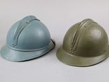 two helmets sitting next to each other on a white surface