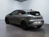 the rear end of a silver car in a white room