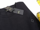 a close up of a black t - shirt with a yellow flower on it