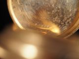 a close up picture of a gold pocket watch