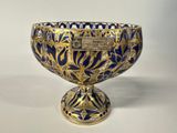 an image of a blue and gold bowl on a white surface