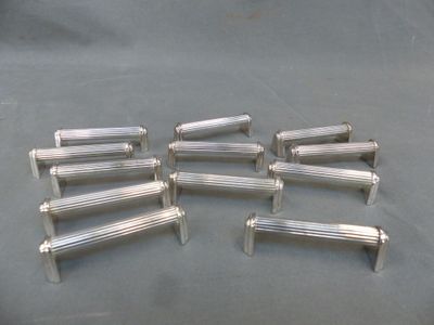 six silver plated metal handles on a gray background