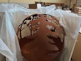a large metal sphere sitting in a box on a table