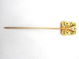 a close up of a wooden stick with a flower on it