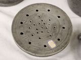 a close up of a metal strainer on a table