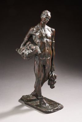 an image of a bronze statue of a man holding a basket
