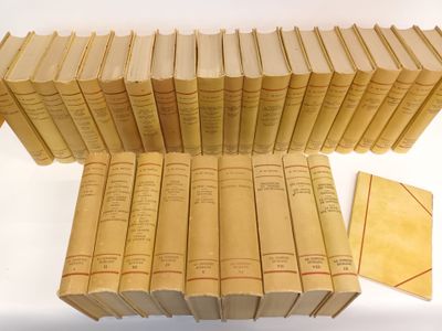 many books stacked on top of each other on a table