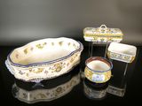 three pieces of pottery sitting on a black surface