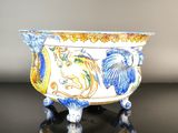 a blue and white bowl sitting on a black table