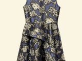 a dress hanging on a hanger on a white wall
