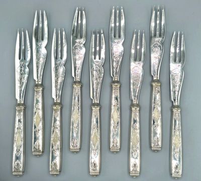 five forks and six knives on a table
