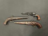 two old guns are sitting on a table next to each other