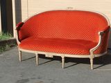 an orange couch sitting in front of a building