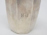 an antique silver vase with the word h on it